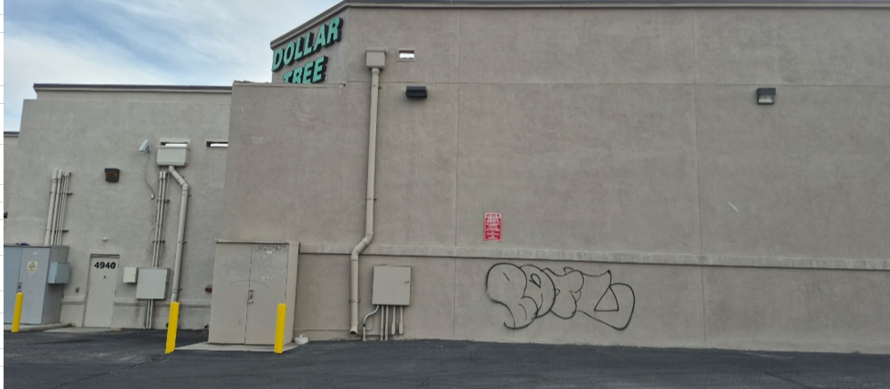 Graffiti removal service on a commercial building wall